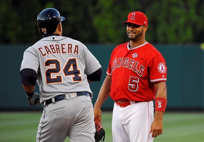 Detroit Tigers' Miguel Cabrera, left, exchanges a few words with Los Angeles Angels first baseman Albert Pujols as he rounds first after hitting a solo home run during the first inning of a baseball game Monday, July 29, 2019, in Anaheim, Calif. (AP Photo/Mark J. Terrill)