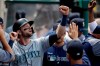 Seattle Mariners' Mitch Haniger celebrates in the dugout after scoring on single during the third inning of a baseball game against the Los Angeles Angels in Anaheim, Calif., Sunday, April 21, 2019. (AP Photo/Chris Carlson)