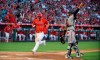 Los Angeles Angels' Mike Trout, left, scores on a sacrifice fly by Justin Upton as Baltimore Orioles catcher Pedro Severino gestures during the first inning of a baseball game, Thursday, July 25, 2019, in Anaheim, Calif. (AP Photo/Mark J. Terrill)