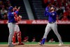 Texas Rangers' Joey Gallo, right, gestures as he scores after hitting a three-run home run as Elvis Andrus, left, waits to congratulate him and Los Angeles Angels catcher Jonathan Lucroy stands at the plate during the first inning of a baseball game Thursday, April 4, 2019, in Anaheim, Calif. (AP Photo/Mark J. Terrill)