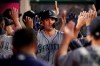 Seattle Mariners' Ryon Healy, center, is greeted by teammates after hitting a thee-run home run during the second inning of a baseball game against the Los Angeles Angels on Thursday, April 18, 2019, in Anaheim, Calif. (AP Photo/Jae C. Hong)