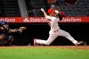 Los Angeles Angels' Andrelton Simmons, right, hits a walk-off single during the 12th inning of a baseball game against the Houston Astros Thursday, Sept. 26, 2019, in Anaheim, Calif. (AP Photo/Mark J. Terrill)