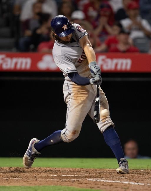 Houston Astros' Jake Marisnick hits an RBI double during the fifth inning of the team's baseball game against the Los Angeles Angels in Anaheim, Calif., Wednesday, July 17, 2019. (AP Photo/Kyusung Gong)