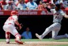 Detroit Tigers' JaCoby Jones, right, slides into home to avoid a tag by Los Angeles Angels catcher Jonathan Lucroy on a single by Niko Goodrum during the third inning of a baseball game in Anaheim, Calif., Wednesday, July 31, 2019. (AP Photo/Alex Gallardo)