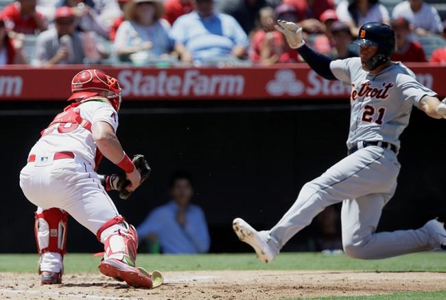 Detroit Tigers' JaCoby Jones, right, slides into home to avoid a tag by Los Angeles Angels catcher Jonathan Lucroy on a single by Niko Goodrum during the third inning of a baseball game in Anaheim, Calif., Wednesday, July 31, 2019. (AP Photo/Alex Gallardo)