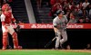 Seattle Mariners' Tom Murphy watches his three-run home run next to Los Angeles Angels catcher Jonathan Lucroy during the sixth inning of a baseball game Friday, June 7, 2019, in Anaheim, Calif. (AP Photo/Mark J. Terrill)
