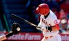 Los Angeles Angels' Mike Trout, right, winces as he is hit by a pitch while Kansas City Royals catcher Cam Gallagher catches during the seventh inning of a baseball game Sunday, May 19, 2019, in Anaheim, Calif. (AP Photo/Mark J. Terrill)