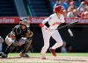 Los Angeles Angels designated hitter Shohei Ohtani, right, watches his two-run home run with Chicago White Sox catcher James McCann, left, during the seventh inning of a baseball game in Anaheim, Calif., Sunday, Aug. 18, 2019. (AP Photo/Alex Gallardo)
