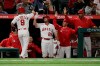 Los Angeles Angels' Tommy La Stella, left, high-fives teammates to celebrate his home run during the fourth inning of a baseball game against the Milwaukee Brewers, Tuesday, April 9, 2019, in Anaheim, Calif. (AP Photo/Jae C. Hong)