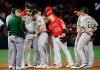 Oakland Athletics' Stephen Piscotty, third from left, is helped off the field after an injury during the sixth inning of the team's baseball game against the Los Angeles Angels on Saturday, June 29, 2019, in Anaheim, Calif. (AP Photo/Marcio Jose Sanchez)