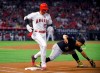 Los Angeles Angels' Shohei Ohtani, left, is safe at first as Pittsburgh Pirates third baseman Jose Osuna takes a late throw during the inning of a baseball game Tuesday, Aug. 13, 2019, in Anaheim, Calif. (AP Photo/Mark J. Terrill)
