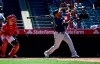 Seattle Mariners' Edwin Encarnacion, right, hits a two-run home run as Los Angeles Angels catcher Jonathan Lucroy watches during the seventh inning of a baseball game Sunday, June 9, 2019, in Anaheim, Calif. (AP Photo/Mark J. Terrill)