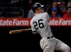 New York Yankees' DJ LeMahieu drives in a run with a single during the ninth inning of a baseball game against the Los Angeles Angels Wednesday, April 24, 2019, in Anaheim, Calif. (AP Photo/Marcio Jose Sanchez)