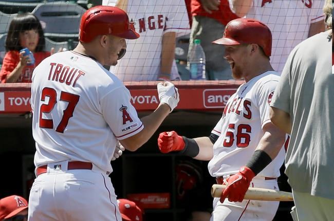 Los Angeles Angels' Kole Calhoun, right, congratulates Mike Trout for Trout's solo home run during the sixth inning of the team's baseball game against the Detroit Tigers in Anaheim, Calif., Wednesday, July 31, 2019. (AP Photo/Alex Gallardo)