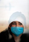 GUILLERMO ARIAS / THE ASSOCIATED PRESS
Mexican worker protects herself from swine flu. A city lab discovered the outbreak.
