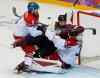 Julio Cortez / The Associated Press
Czech Republic's Michal Barinka (8) and Latvia forward Martins Karsums visit Ondrej Pavelec in the Czech goal in the second period Friday.