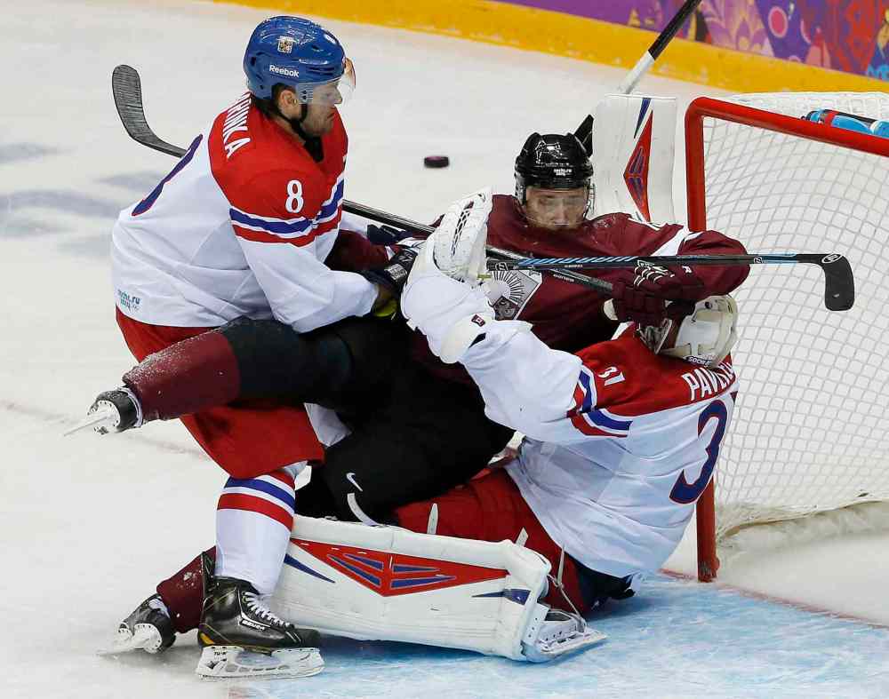 Julio Cortez / The Associated Press
Czech Republic's Michal Barinka (8) and Latvia forward Martins Karsums visit Ondrej Pavelec in the Czech goal in the second period Friday.