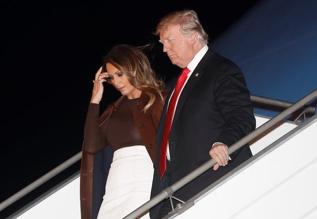 President Donald Trump and first lady Melania Trump walk from Air Force One, Thursday, Nov. 29, 2018, as they arrive at the Ministro Pistarini international airport in Buenos Aires, Argentina. Trump traveled to Argentina to attend the G20 summit. (AP Photo/Pablo Martinez Monsivais)