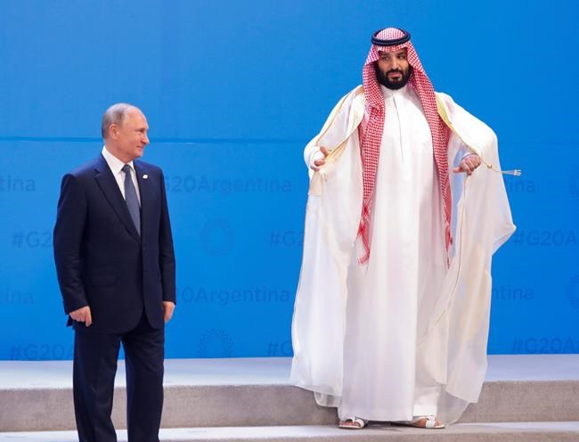 Russia's President Vladimir Putin, left, and Saudi Arabia's Crown Prince Mohammed bin Salman, right, wait for other heads of state for the group photo at the start of the G20 summit in Buenos Aires, Argentina, Friday, Nov. 30, 2018. Leaders from the Group of 20 industrialized nations are meeting in Buenos Aires for two days starting today.(AP Photo/Pablo Martinez Monsivais)