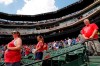 Fans stand during a moment of silence observed by the Texas Rangers and Seattle Mariners in remembrance of those killed in the shootings in Odessa, Texas, before a baseball game between the two clubs in Arlington, Texas, Sunday, Sept. 1, 2019. (AP Photo/Tony Gutierrez)