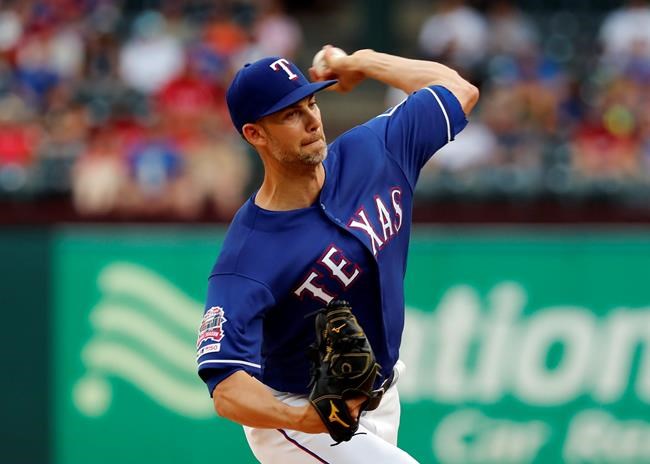Texas Rangers starting pitcher Mike Minor throws to a Kansas City Royals batter during the first inning of a baseball game in Arlington, Texas, Thursday, May 30, 2019. (AP Photo/Tony Gutierrez)