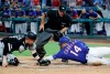 Chicago White Sox catcher Zack Collins, left, reaches to tag out Texas Rangers' Asdrubal Cabrera (14) as umpire Ed Hickox looks on in the first inning of a baseball game in Arlington, Texas, Saturday, June 22, 2019. Cabrera was trying to score on a double by Logan Forsythe. (AP Photo/Tony Gutierrez)