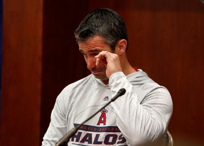 Los Angeles Angels manager Brad Ausmus wipes tears from his eyes as he responds to questions during a news conference about the passing of Tyler Skaggs, before a baseball game against the Texas Rangers in Arlington, Texas, Tuesday, July 2, 2019. (AP Photo/Tony Gutierrez)