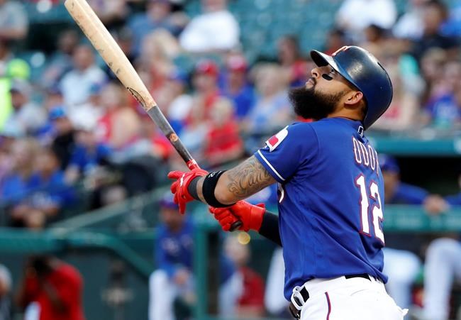 Texas Rangers' Rougned Odor follows through on an RBI double in the first inning of the team's baseball game against the Seattle Mariners in Arlington, Texas, Wednesday, July 31, 2019. (AP Photo/Tony Gutierrez)