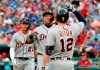 Detroit Tigers' Miguel Cabrera, center, and Brandon Dixon (12) celebrate Cabrera's two-run home run that scored JaCoby Jones, rear, during the first inning of a baseball game against the Texas Rangers in Arlington, Texas, Saturday, Aug. 3, 2019. (AP Photo/Tony Gutierrez)
