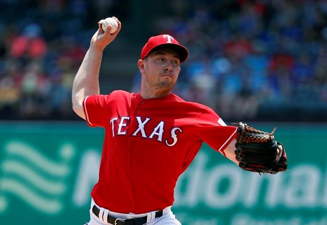 Texas Rangers' Adrian Sampson throws to the Seattle Mariners in the fourth inning of a baseball game in Arlington, Texas, Wednesday, May 22, 2019. (AP Photo/Tony Gutierrez)