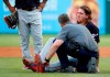 A member of the Cleveland Indians staff checks on starting pitcher Mike Clevinger, right, who fell off the mound while delivering a pitch to the Texas Rangers in the second inning of baseball game in Arlington, Texas, Monday, June 17, 2019. Clevinger continued playing in the game. (AP Photo/Tony Gutierrez)