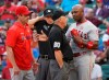 Los Angeles Angels Justin Upton, who had struck out, questions umpire Tom Hallion (20) during the third inning of the team's baseball game against the Los Angeles Angels on Wednesday, Aug. 21, 2019,in Arlington, Texas. Angels manager Brad Ausmus is at left. (AP Photo/Louis DeLuca)