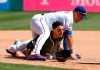 Texas Rangers third baseman Asdrubal Cabrera lands atop Oakland Athletics' Ramon Laureano who advanced to the bag on a Josh Phegley run-scoring single in the fourth inning of a baseball game in Arlington, Texas, Sunday, April 14, 2019. Athletics' Jurickson Profar scored on the play. (AP Photo/Tony Gutierrez)