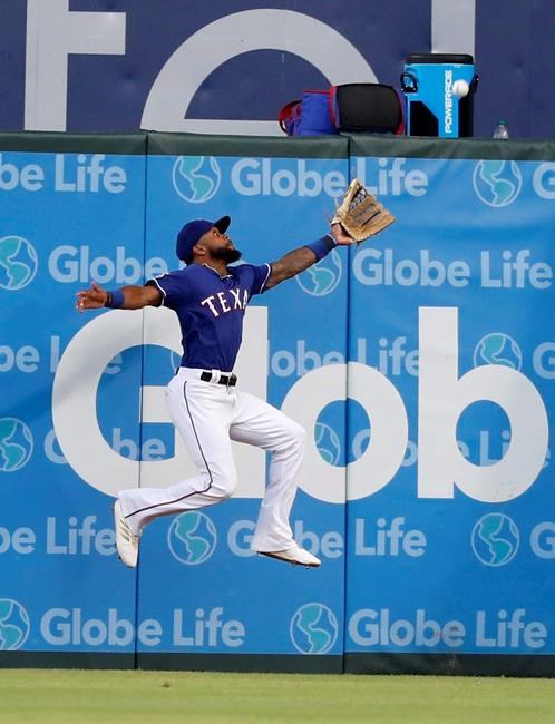 Texas Rangers center fielder Delino DeShields is unable to reach a bases clearing double hit by Chicago White Sox's Tim Anderson in the first inning of a baseball game in Arlington, Texas, Saturday, June 22, 2019. (AP Photo/Tony Gutierrez)
