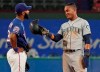 Seattle Mariners' Mallex Smith, right, jokes with Texas Rangers shortstop Danny Santana after stealing second base during the fifth inning of a baseball game Thursday, Aug. 29, 2019, in Arlington, Texas. (AP Photo/Louis DeLuca)