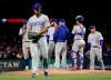 Chicago Cubs starting pitcher Yu Darvish (11) walks to the dugout after being pulled in the third inning of a baseball game against the Texas Rangers in Arlington, Texas, Saturday, March 30, 2019. (AP Photo/Tony Gutierrez)