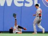 Baltimore Orioles left fielder Dwight Smith Jr. holds his glove up after hitting the wall making a catch for the out on a fly ball by Texas Rangers' Rougned Odor, as center fielder Stevie Wilkerson looks on during the fourth inning of a baseball game in Arlington, Texas, Thursday, June 6, 2019. (AP Photo/Tony Gutierrez)