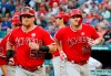 Los Angeles Angels' Kole Calhoun and Mike Trout, right, jog to the dugout after Trout's three-run home run during the third inning of the team's baseball game against the Texas Rangers in Arlington, Texas, Wednesday, July 3, 2019. (AP Photo/Tony Gutierrez)