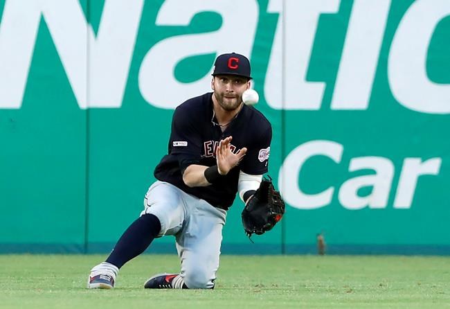 Cleveland Indians right fielder Tyler Naquin makes a sliding catch on a flyout by Texas Rangers' Delino DeShields in the third inning of baseball game in Arlington, Texas, Monday, June 17, 2019. (AP Photo/Tony Gutierrez)