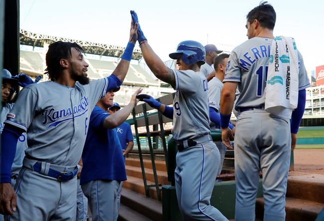 Kansas City Royals' Billy Hamilton, left, and Whit Merrifield, right, and the rest of the dugout celebrate with Cheslor Cuthbert, center, after Cuthbert hit a solo home run off of Texas Rangers' Ariel Jurado during the second inning of a baseball game in Arlington, Texas, Friday, May 31, 2019. (AP Photo/Tony Gutierrez)
