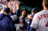 Houston Astros' Michael Brantley (23) is congratulated by teammates after scoring on a double by Carlos Correa during the fifth inning of a baseball game against the Texas Rangers, Friday, April 19, 2019, in Arlington, Texas. (AP Photo/Brandon Wade)
