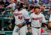 Minnesota Twins' Miguel Sano (22) and Jorge Polanco (11) look down the third base line after the two scored on a C.J. Cron single in the fourth inning of a baseball game against the Texas Rangers in Arlington, Texas, Thursday, Aug. 15, 2019. (AP Photo/Tony Gutierrez)