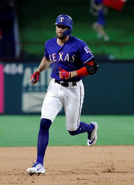 Texas Rangers' Hunter Pence rounds the bases after hitting a two-run home run off Seattle Mariners relief pitcher Ryan Garton in the seventh inning of a baseball game in Arlington, Texas, Monday, May 20, 2019. The shot also scored Nomar Mazara. (AP Photo/Tony Gutierrez)