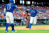 Texas Rangers' Rougned Odor, right, is congratulated by Shin-Soo Choo (17) after scoring on an RBI single by Jeff Mathis during the third inning of a baseball game against the Houston Astros Thursday, July 11, 2019, in Arlington, Texas. (AP Photo/Jeffrey McWhorter)