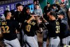Pittsburgh Pirates' Elias Diaz (32), Keone Kela (35) and teammates congratulate Bryan Reynolds (10) on his solo home run in the 11th inning of a baseball game against the Texas Rangers in Arlington, Texas, Tuesday, April 30, 2019. (AP Photo/Tony Gutierrez)