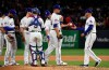 Texas Rangers starting pitcher Drew Smyly hands the ball to manager Chris Woodward as he is pulled during the sixth inning of a baseball game against the Oakland Athletics on Friday, April 12, 2019, in Arlington, Texas. (AP Photo/Jeffrey McWhorter)