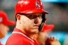 Los Angeles Angels designated hitter Mike Trout looks from the dugout as he waits to bat against the Texas Rangers during the eighth inning of a baseball game Monday, April 15, 2019, in Arlington, Texas. (AP Photo/Michael Ainsworth)