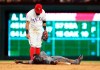Texas Rangers second baseman Rougned Odor (12) looks down at Arizona Diamondbacks Jarrod Dyson, who was forced out during the sixth inning of a baseball game Wednesday, July 17, 2019, in Arlington, Texas. Dyson left the game after the play. (AP Photo/Richard W. Rodriguez)