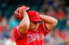 Los Angeles Angels starting pitcher Jose Suarez adjust his cap that has a written message on it referring to teammate Tyler Skaggs during a baseball game against the Texas Rangers in Arlington, Texas, Tuesday, July 2, 2019. (AP Photo/Tony Gutierrez)