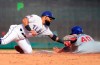 Texas Rangers second baseman Rougned Odor (12) tags out Chicago Cubs Willson Contreras (40) on a steal attempt during the fifth inning of a baseball game Thursday, March 28, 2019 in Arlington, Texas. (AP Photo/Richard W. Rodriguez)